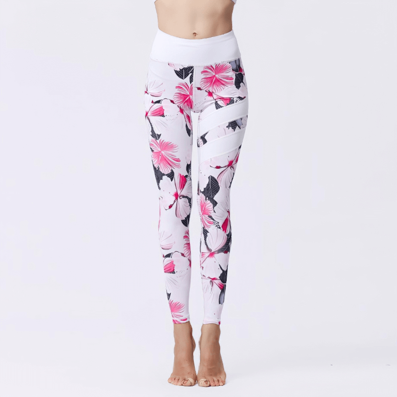 Women's high-waist sports leggings with pink flower prints, perfect for yoga or fitness, featuring stretchy, breathable fabric.